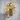Submachine gun pendant, gold vermeil, product photo against wood