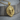 Layered Lion Pendant, gold vermeil, front view on wood base