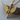 Winged Arrow Pendant, gold vermeil, angled view on wood block