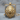 Roaring Lion Head Pendant, gold vermeil, front view on wood block