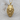 Wolf maiden pendant, gold vermeil, product photo on wood surface