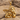 Resting Angel Pendant, gold vermeil, product photo on driftwood and sand