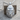 Primate Head Pendant, polished silver, front view on wood block