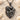 Mother Baby Sun Pendant, black rhodium, front view on sand