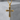 Black Cross Pendant, gold vermeil, front view on stone pedestal
