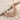 Scroll Crescent Star Pendant, rose gold, angled view on sand with driftwood