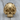 Ribbed Biomechanical Skull Ring, gold vermeil, front view on wood surface
