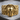 Spartan Helmet Skull Ring, gold vermeil, front view on wood