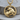 Rearing Taurus Zodiac Pendant, gold vermeil, product photo on wood