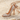 Stiletto High Heel Pendant, rose gold, angled view on sand
