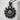 Bloom sunflower pendant, black rhodium plated, front view on concrete block