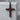 Ruby cross pendant, black rhodium, front product view on stone pedestal