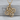 Quaternary Celtic Knot Pendant, gold vermeil, product photo on stone surface