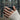 Jormungandr Wave Pool Ring, oxidized, worn on model hand holding a mug