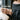 Amethyst Lily ID Bracelet, rose gold, worn on model wrist holding a cup