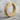 Gothic Cross Hoop Earring, gold vermeil, product photo on neutral stone