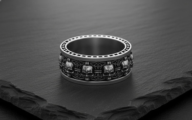 925 sterling silver heraldic skull ring featuring alternating skull and fleur-de-lis symbols on dark slate background