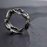 925 sterling silver lovers ring with male and female figures forming a circle on dark slate