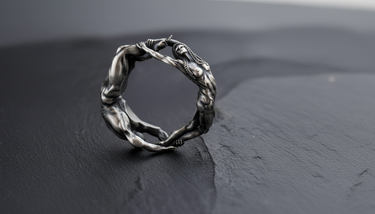 925 sterling silver lovers ring with male and female figures forming a circle on dark slate