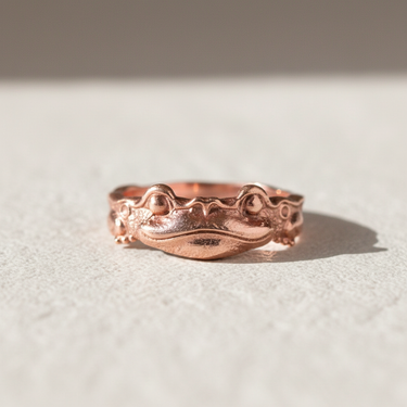 Rose gold plated 925 sterling silver frog ring with textured details displayed on a light background