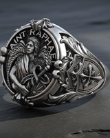 Close-up of Saint Raphael Archangel face and text engraving on oxidized silver signet ring