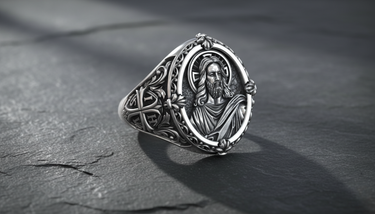 Front view of 925 sterling silver Jesus Christ ring with halo and floral border on dark stone background