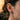 Model wearing handcrafted silver angel earring showing detailed wing and shhh gesture on ear