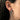 Side view of model wearing climbing cat silver earring showing secure fit on earlobe and detailed design