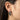 Model wearing silver dragon huggie earrings showing size and detailed craftsmanship