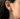 Side profile view of silver dryad earring worn on ear showing hoop size and intricate facial details of the forest spirit