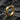 14K gold vermeil geometric hoop earring with faceted design on dark stone background