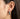 Close-up of model wearing silver ghost earring showing size and fit on the earlobe with lever-back mechanism
