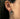 Model wearing silver wizard earring showing detailed craftsmanship of reading figure on ear