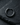 Black rhodium plated 925 sterling silver segmented hoop earring displayed on a textured dark stone background