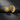 Gold vermeil sun and moon earrings with detailed human faces displayed on dark slate stone background