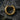 Close-up of 14K gold vermeil textured hoop earring with rugged surface detail on dark stone background