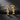 Pair of 14K gold vermeil theater muse earrings with comedy and tragedy masks on black stone background