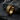 14K gold vermeil huggie hoop earring with geometric tire tread pattern on dark stone background