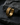 14K gold vermeil huggie hoop earring with geometric tire tread pattern on dark stone background