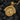 Sacred Flame Medallion Pendant, gold finish, front view on charcoal